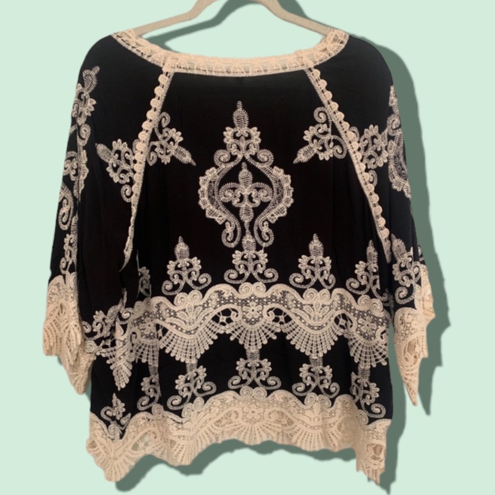 Beautiful blouse with crocheted hem and sleeves.